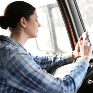 Female trucker using TruckLogics trucker mobile App for fleet management