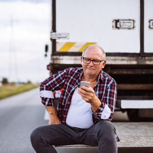 Trucker using TruckLogics mobile app for trucking dispatch.