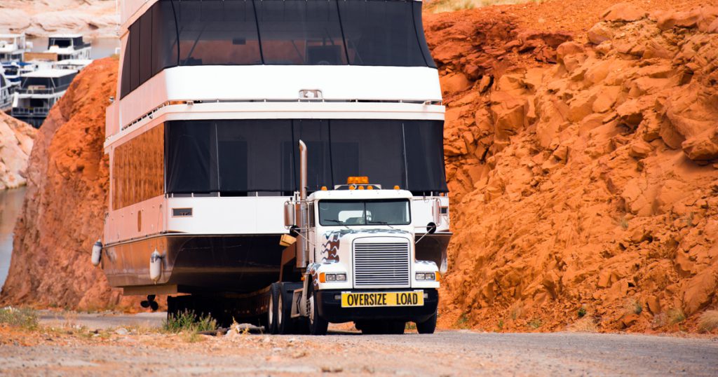 Truck hauling a boat load found by freight broker with trucklogics tms