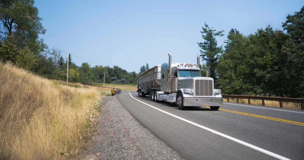 Trucker driving on interstate using TruckLogics trucking dispatch software.