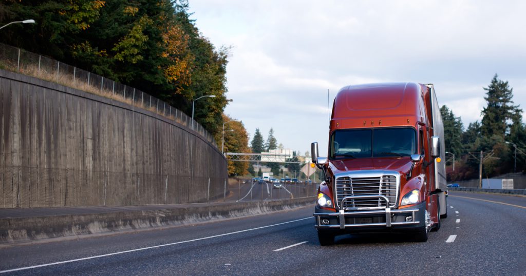 orange truck on interstate managing truck maintenance expenses