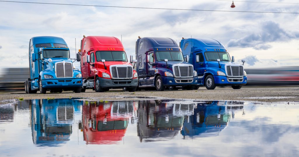 Company fleet drivers parked using TruckLogics trucking management software mobile app